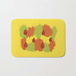 Autumn leaves and ladybugs bathmat at Society6