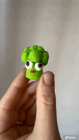 Funny broccoli character animation showing a tiny broccoli clay figurine with big eyes and stuck out tongue