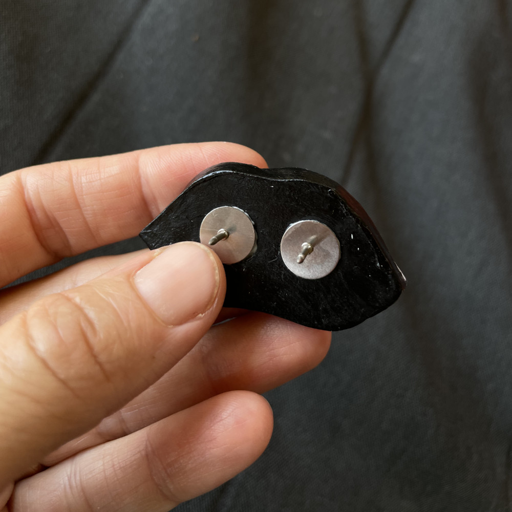 back of the badge with two pins