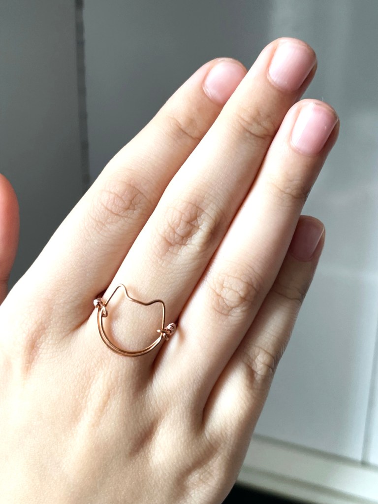 cat head handmade copper ring on girl hand. Made by Boriana Giormova, Sofia, Bulgaria