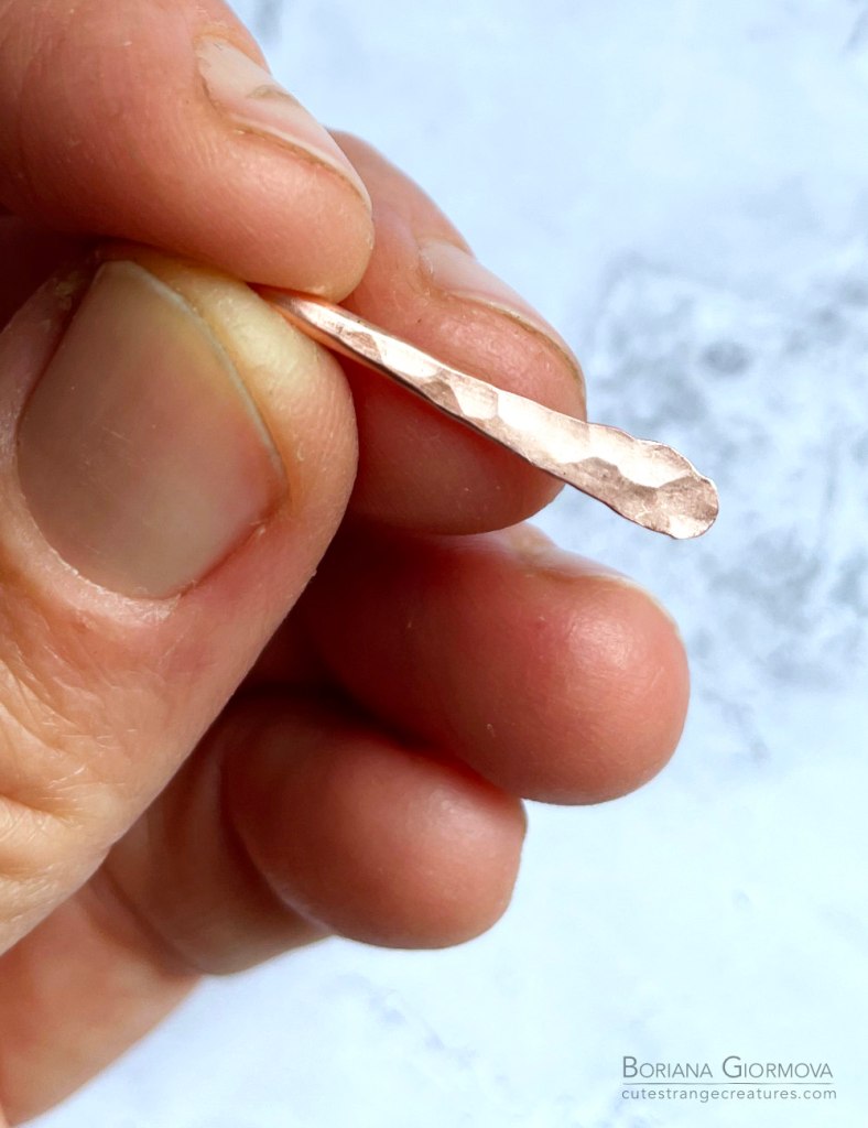 one of the copper elements for the earrings showing the hammered texture