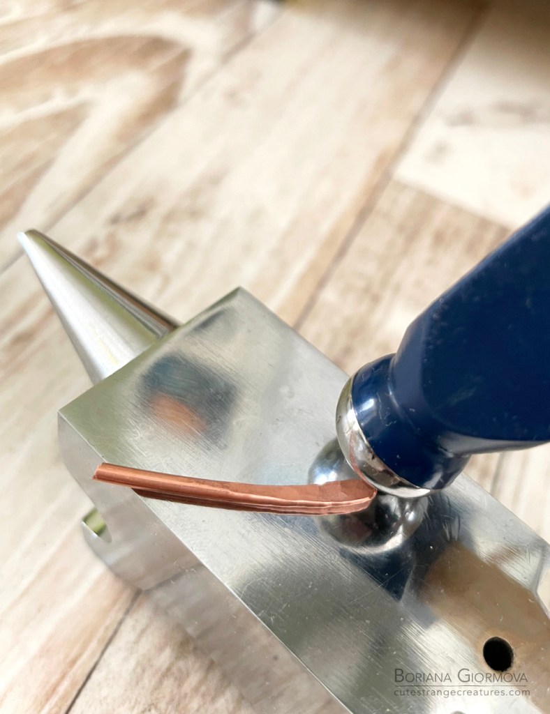 hammering the wire on the anvil