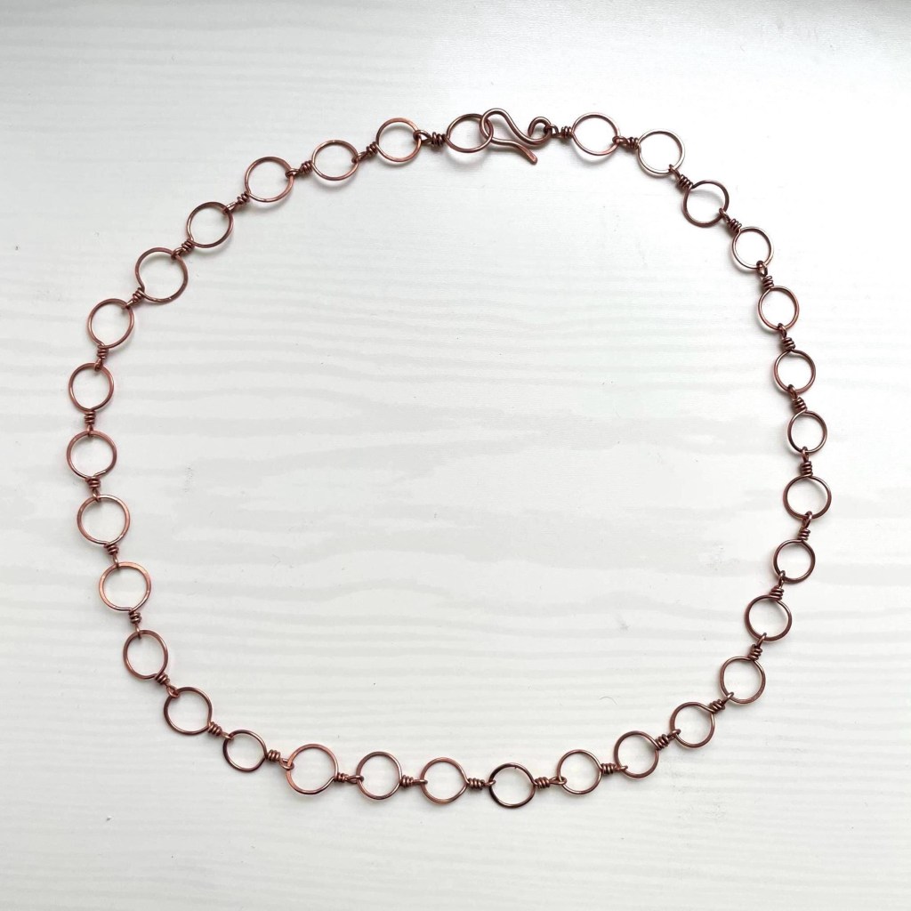 the necklace arranged in a closed circle