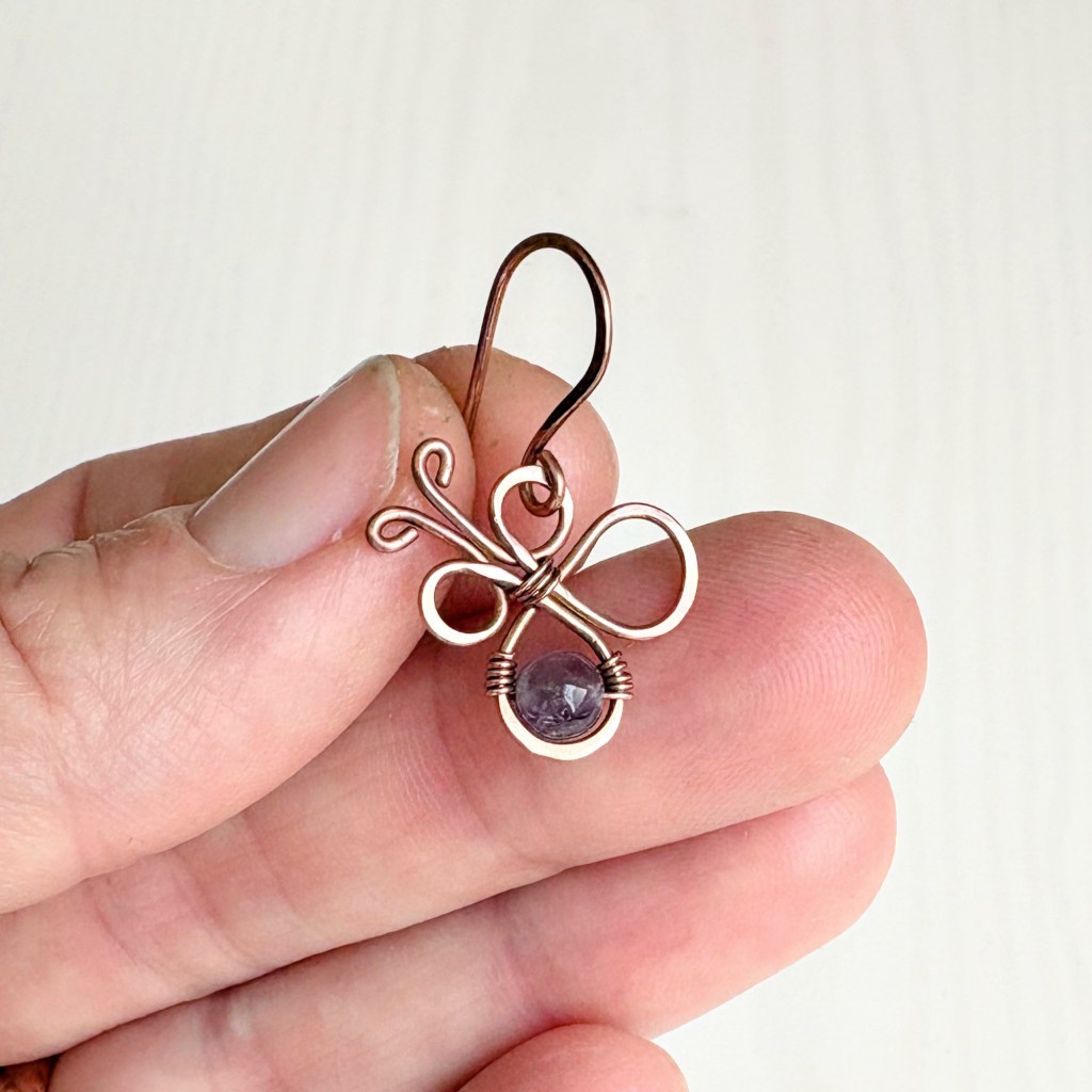 earring held in hand - front