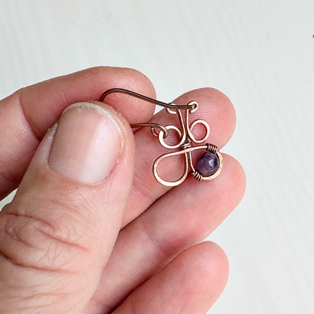 earring held in hand - back