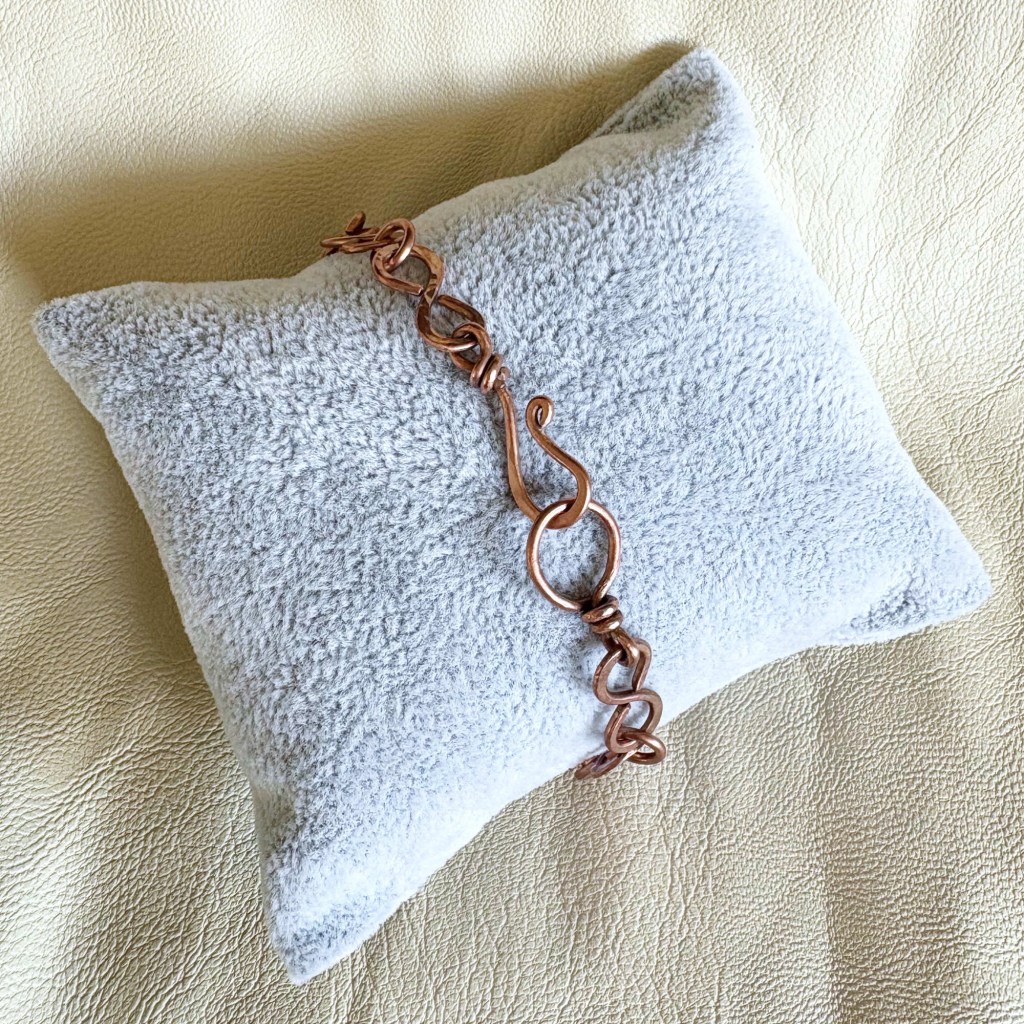 Bracelet on jewelry pillow clasp shown