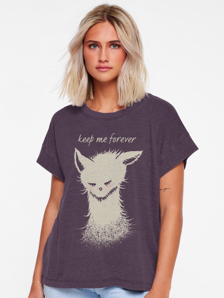 Woman wearing a dark purple relaxed-fit T-shirt featuring a cream-colored sleeping cat illustration and the words “keep me forever” on the front.